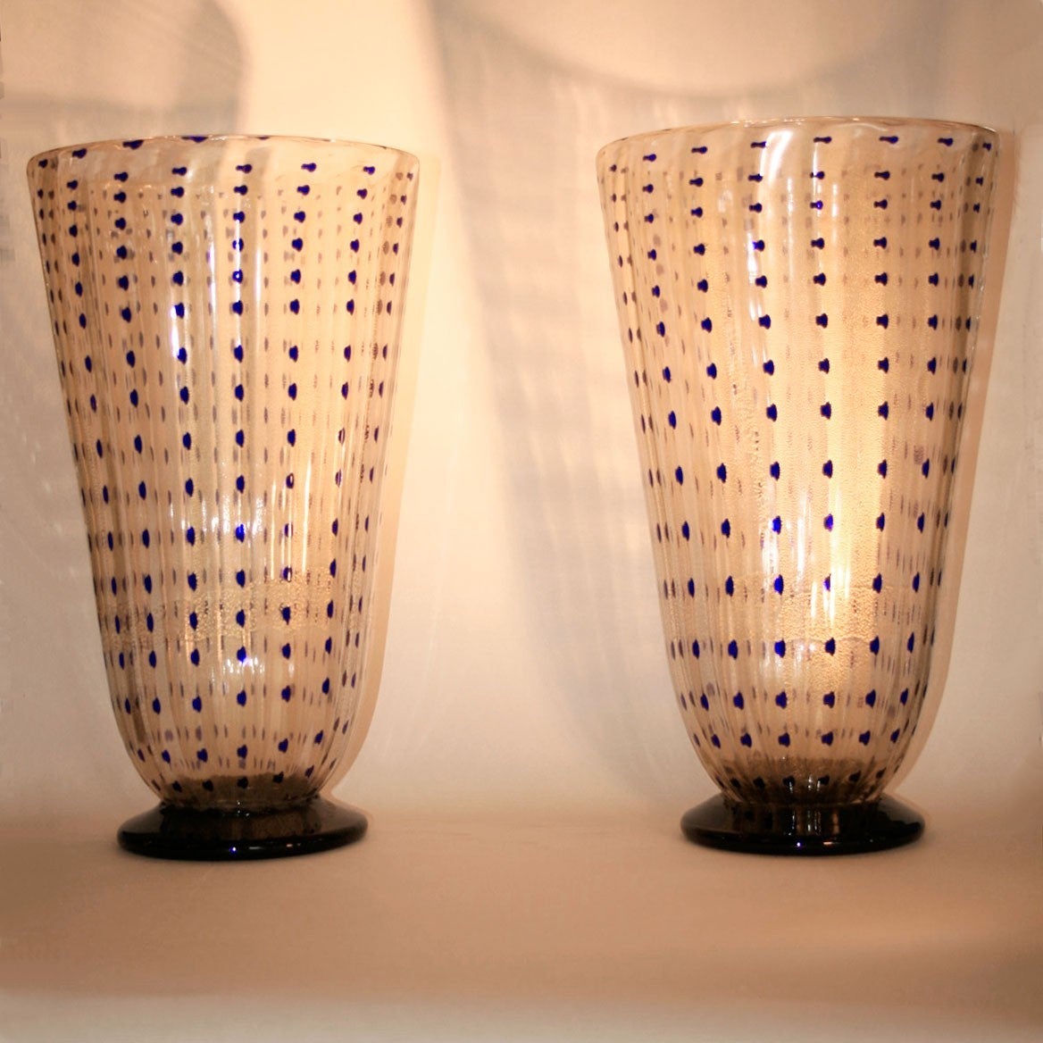 Exquisite pair of tall vases, handblown in clear glass, gently tapering outwards, with consecutive dabs of indigo on a gold flecked background, standing on circular bases signed underneath: 'Barovier Toso Murano' (see detailed image).