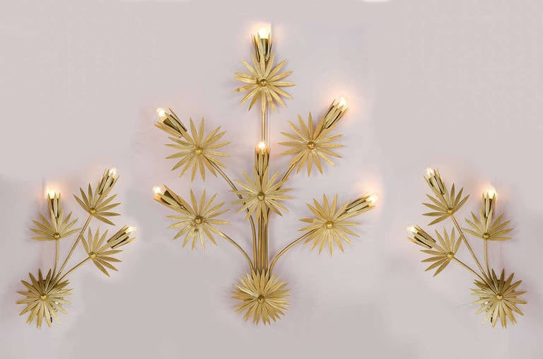 Rare set of three 'Gilded' wall lights, in the form of sprigs of stylized flowers. Each stylised leaf is delicately etched and each flower is made up of a double layer to add to decorative appeal
30.25 inches high x 21.5inches wide (the largest),