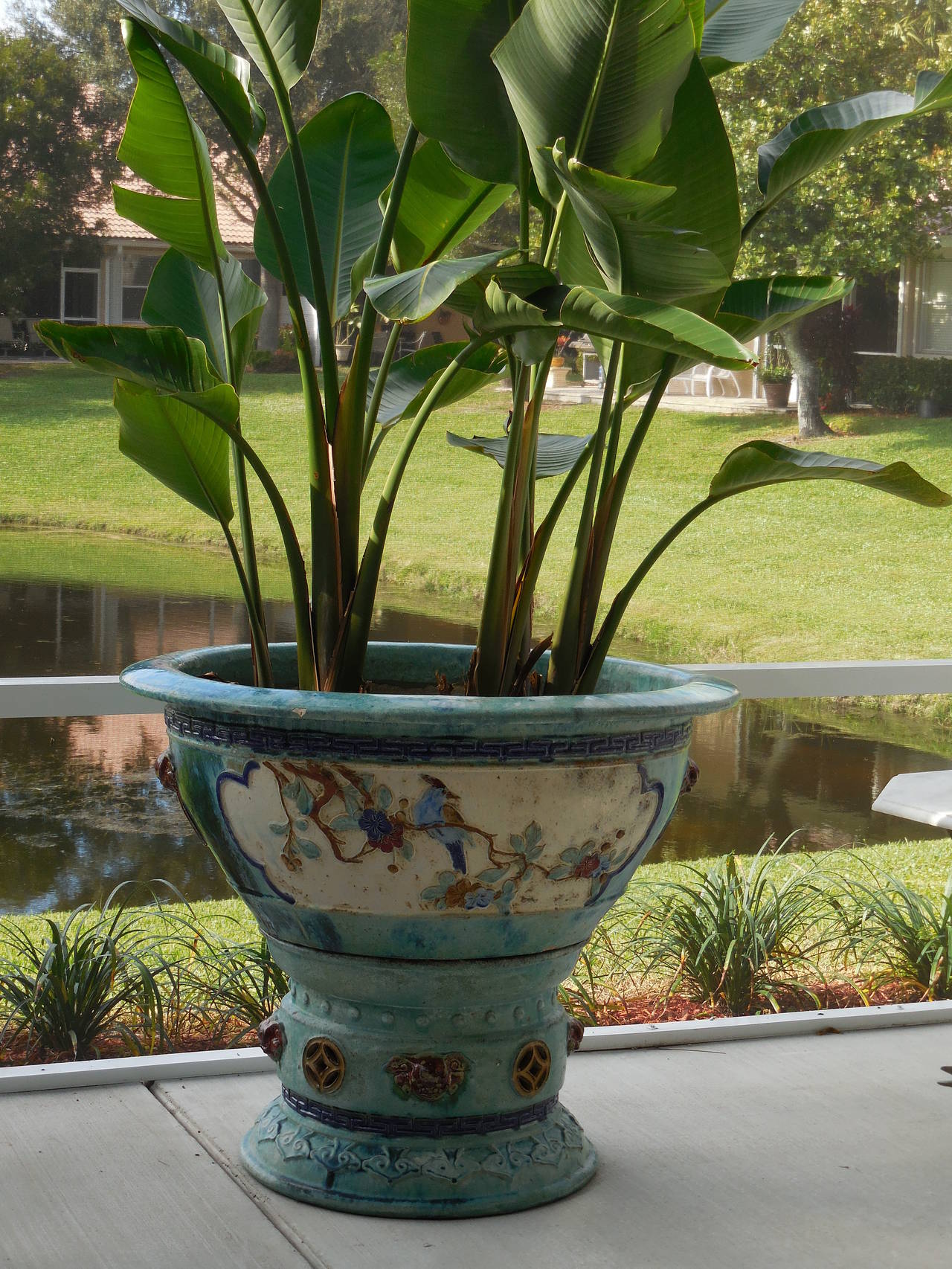 Beautiful ceramic planter made of two separate pieces, base and large round top. Both surrounded with garden plants and floral motif, round circle border, bird
and Foo dog.
Unusual colors texture with dominant turquoise.
Could be used