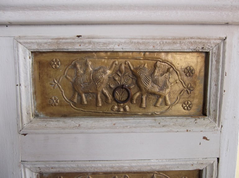 Unusual wood cabinet with artistic brass work in the front,
of animal and birds.
Great to use as console in narrow space.