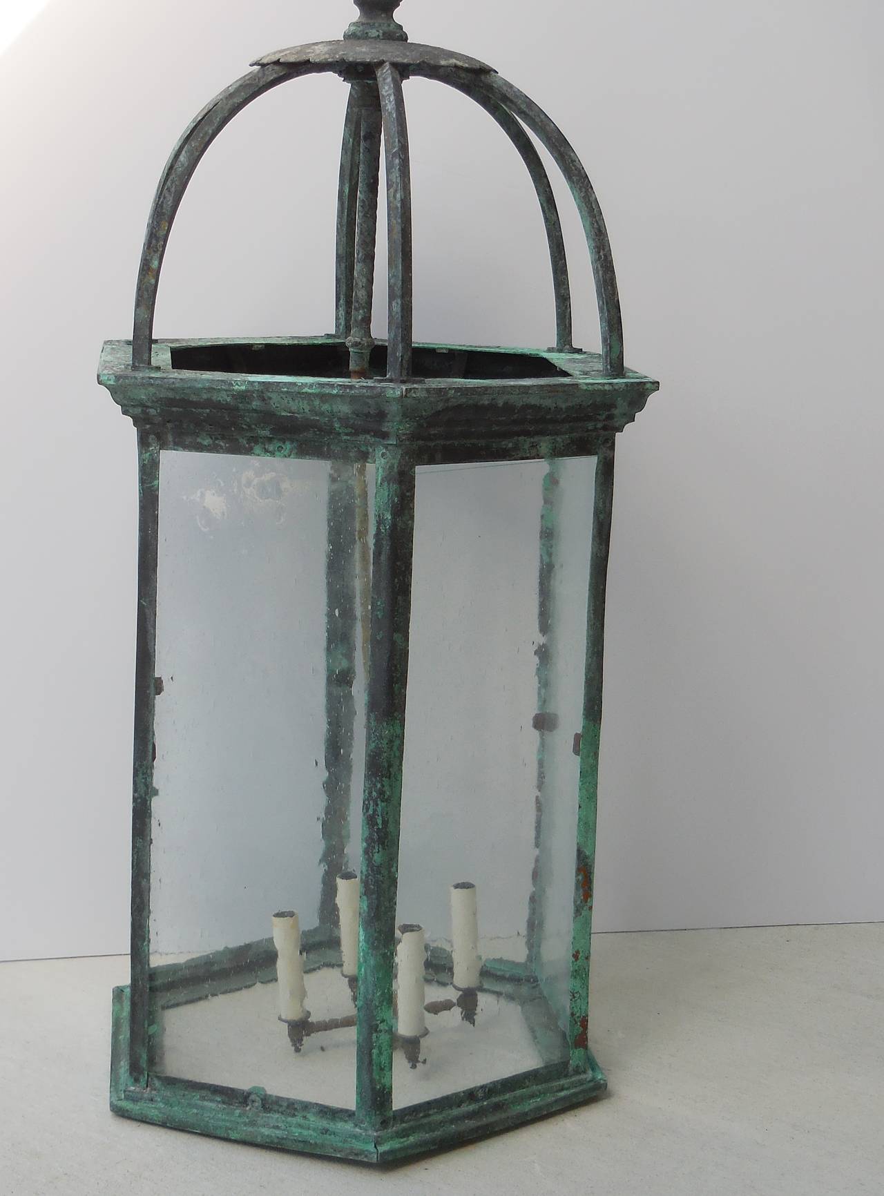 Unusal antique lantern made of copper ,six long sides with seeded glass .
New brass cluster of four /60/ watt light electrified and ready to light .
The antique lantern is a salvage of un old estate in palm beach Florida .