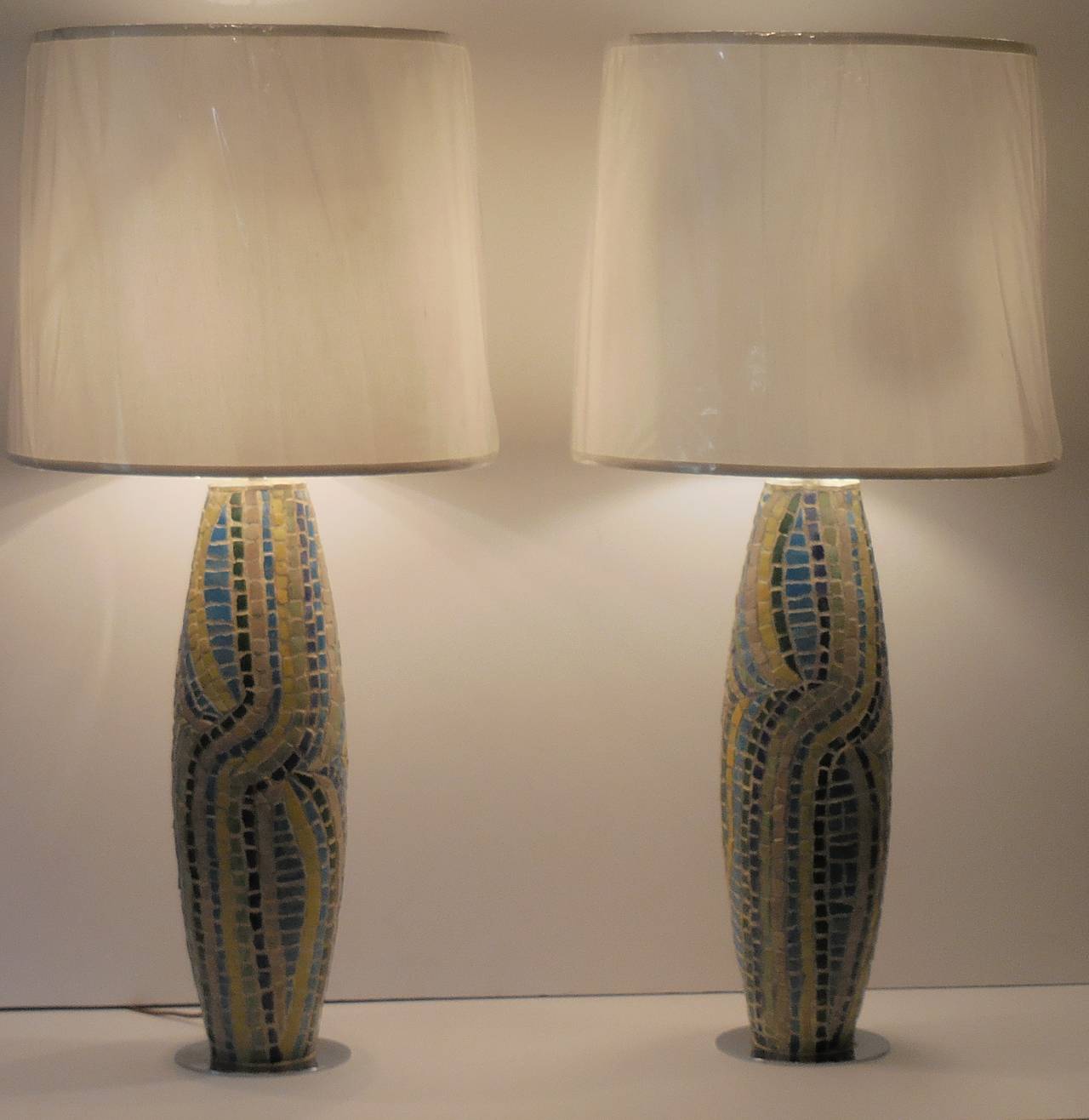 One of a kind table lamps made of wooden body of the lamps surrounded, 
all around with qubist design of broken Persian pottery.
Beautiful colors of green, turquoise, cobalt blue, yellow and cream colors.
Special switch on and off is from the