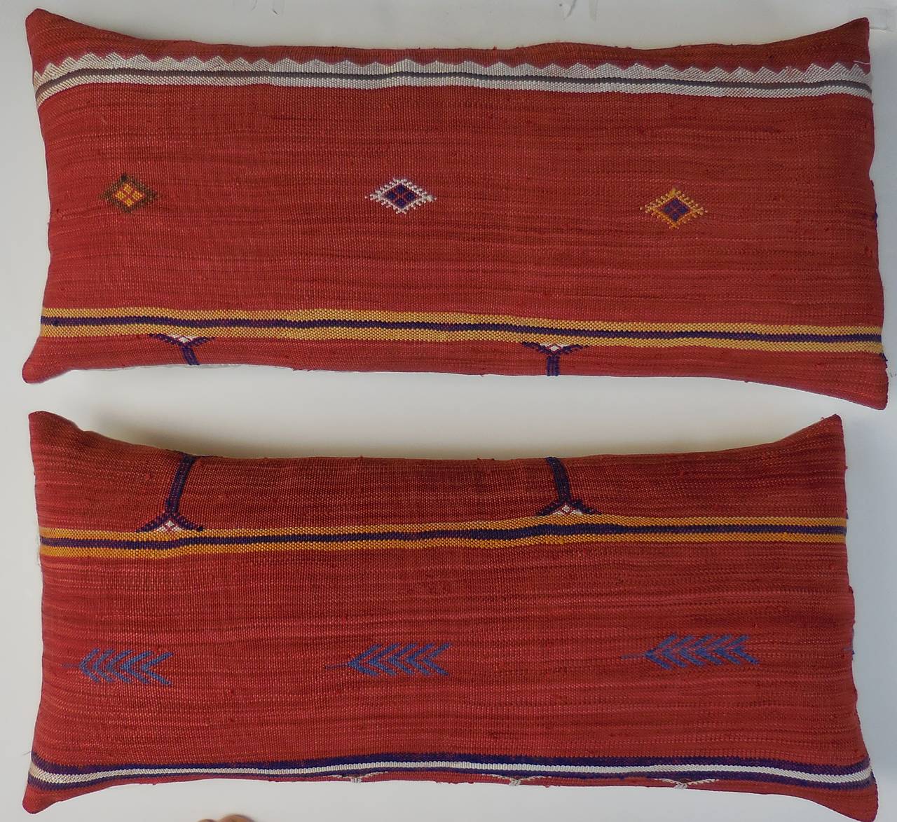 Pair of pillows ,made of hand woven rug fragment with geometric motif.
Silk backing. 
Frash inserts.