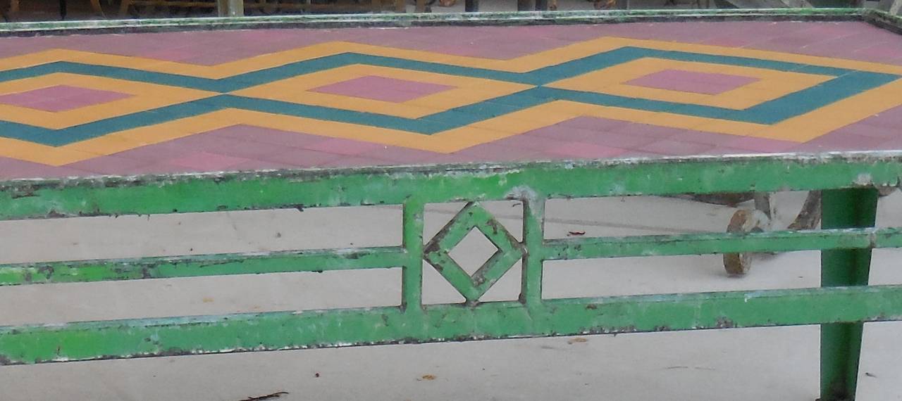 Beautiful weathered tile table made of metal frame with small colorful ceramic tiles from the 1960s. Embedded into it, in geometric shape.
Great as coffee table indoor or outdoor.
Rust treated.