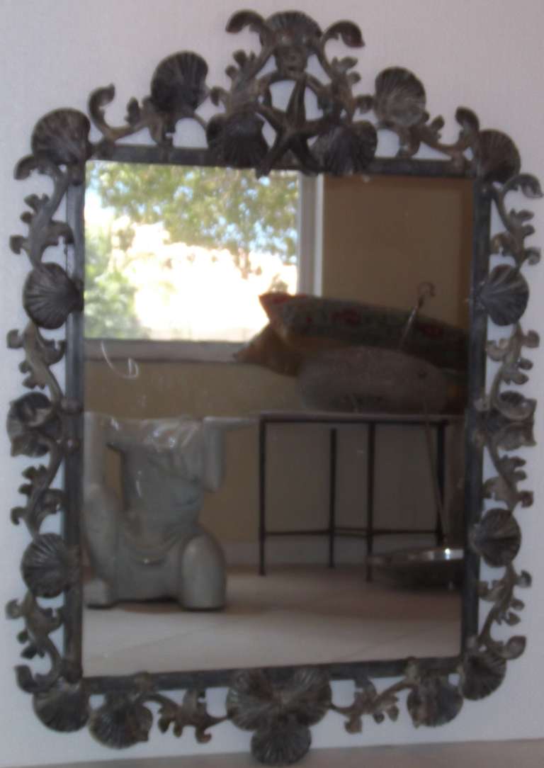Beautiful artistic seashell mirror,made of forge iron and cast iron with shell and 
Sea star motifs .
The mirror have great patina .