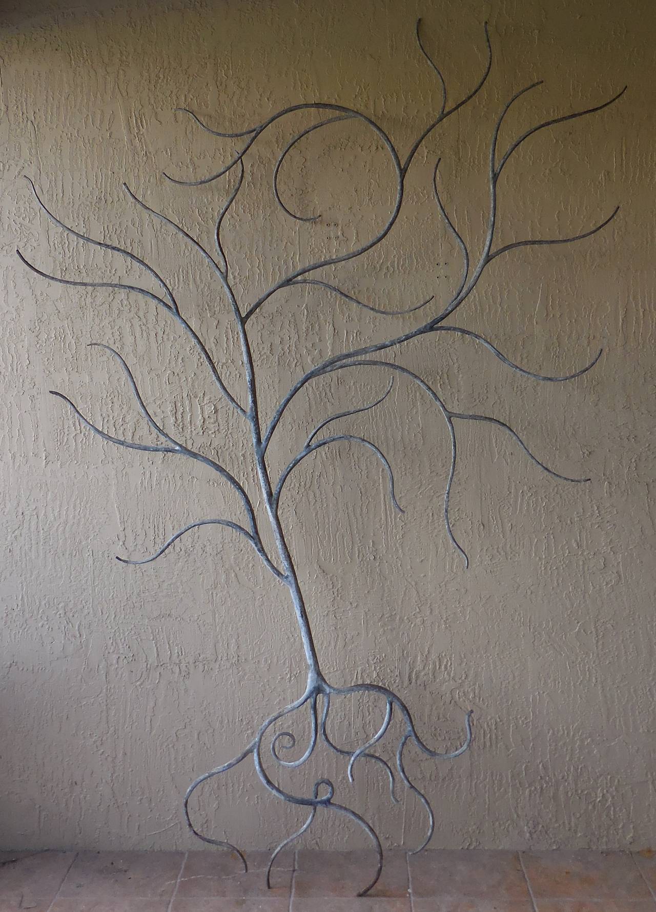 Unusual large tree made of hand forage iron by unknown artist in the 1960s.
Scrolling branches all around.
One of a kind decorative piece of art.
Thickness of the trunk and branches is from 2