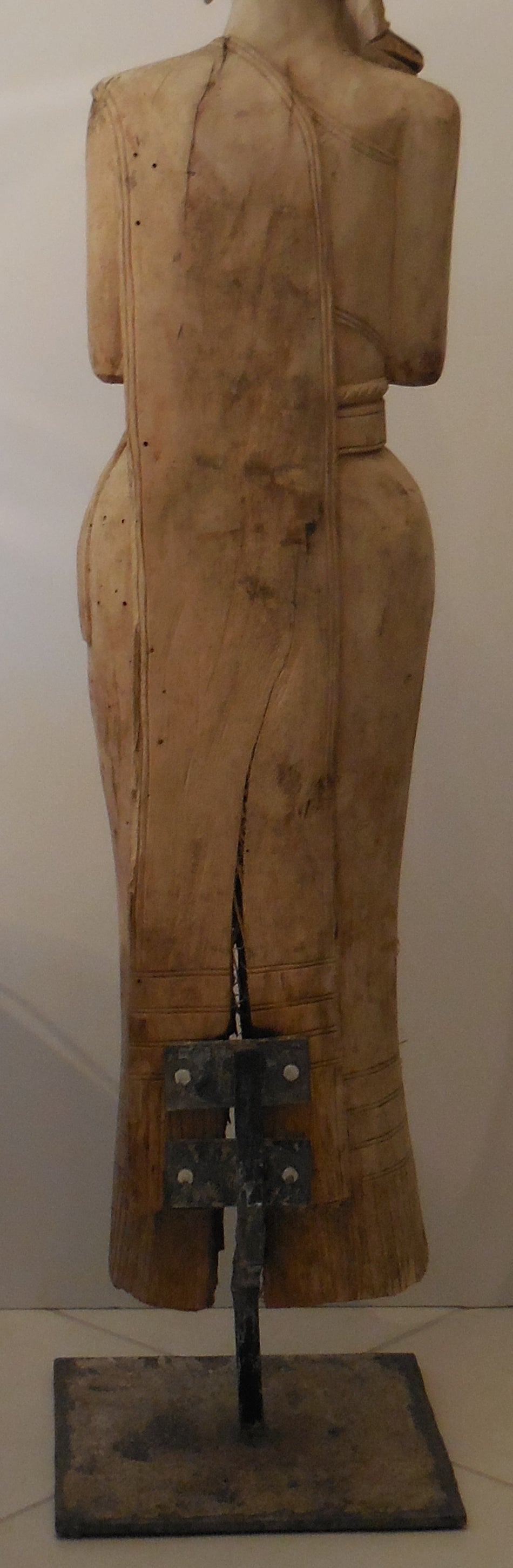 Large quan yin statute made of hand-carved wood with beautiful face, vertical
split in the wood because of time and the eliminate. The statue is place on a 
custom-made iron base.
Base size 12