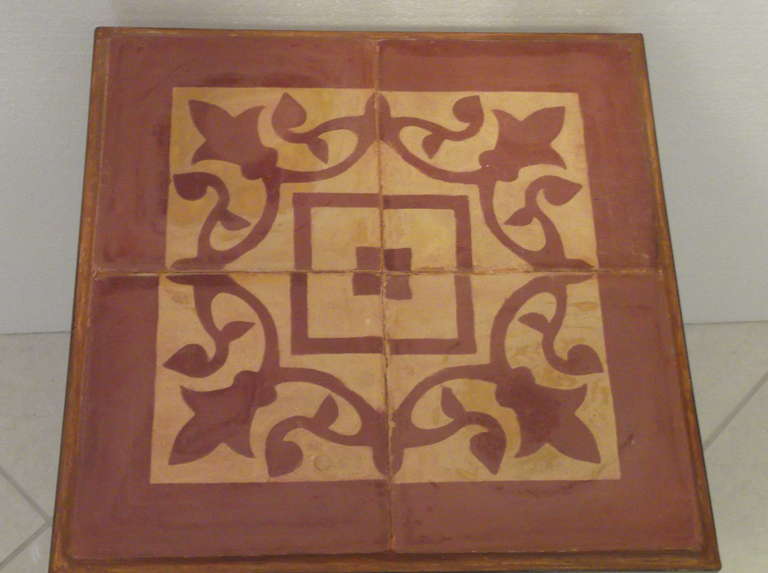 Beautiful tile table made of four tiles on a iron frame with elegant legs.
Vine motif on salmon yellow color.
The legs are lightly hand-painted.