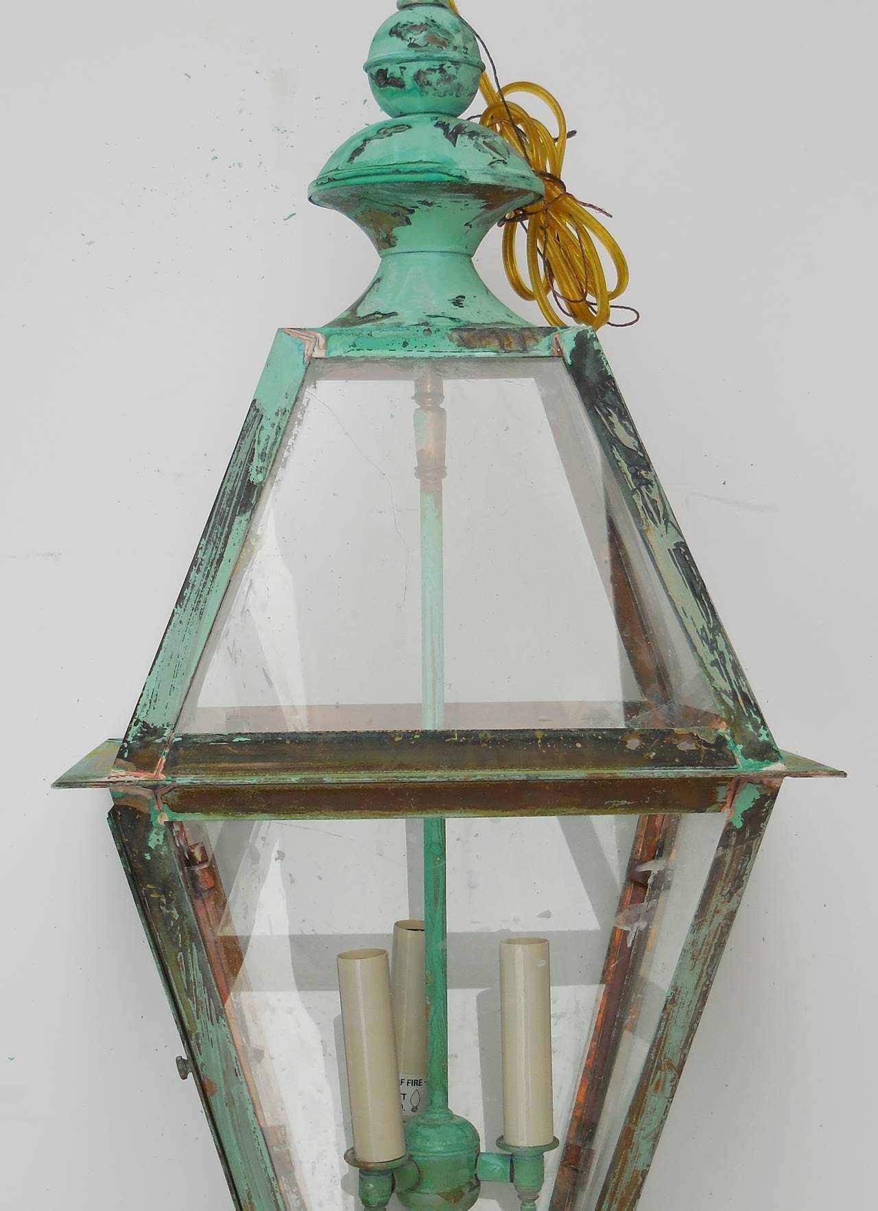 Beautifully  weathered  lantern  made of copper, with three 60 watt lights.
Electrified and ready to light.
Made in the US and UL approved .
Could be used in wet location and inside.
Chain and canopy included.