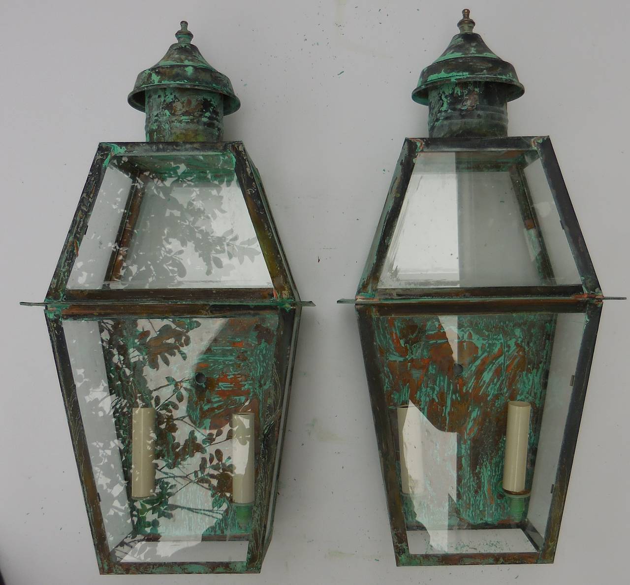 Pair of architectural wall lanterns, made of copper, with two 60/watt light each.
Electrified and ready to light. Suited for dry or wet location. UL approved.