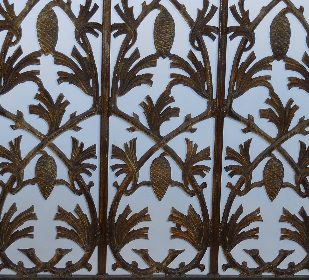 Beautiful fireplace screen made of cast iron with vines and pinecone motif
all around. Decorative legs, with great looking overall patina.