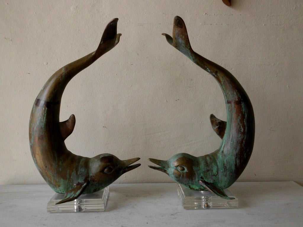 Pair of beautiful and weathered brass dolphins ,mounted on a lucite base.
Lucite base is 6