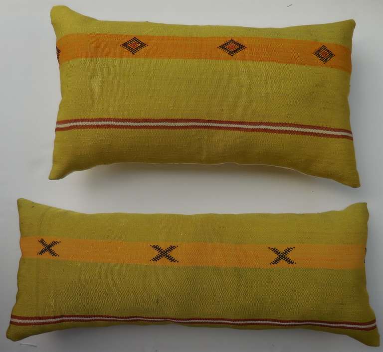 Beautiful pair of pillows made of handwoven rug fragment, unusual lime color with geometric motifs. New inserts.

Sizes: 1. 23" x 13" x 5".

2. 27" x 11" x 5".