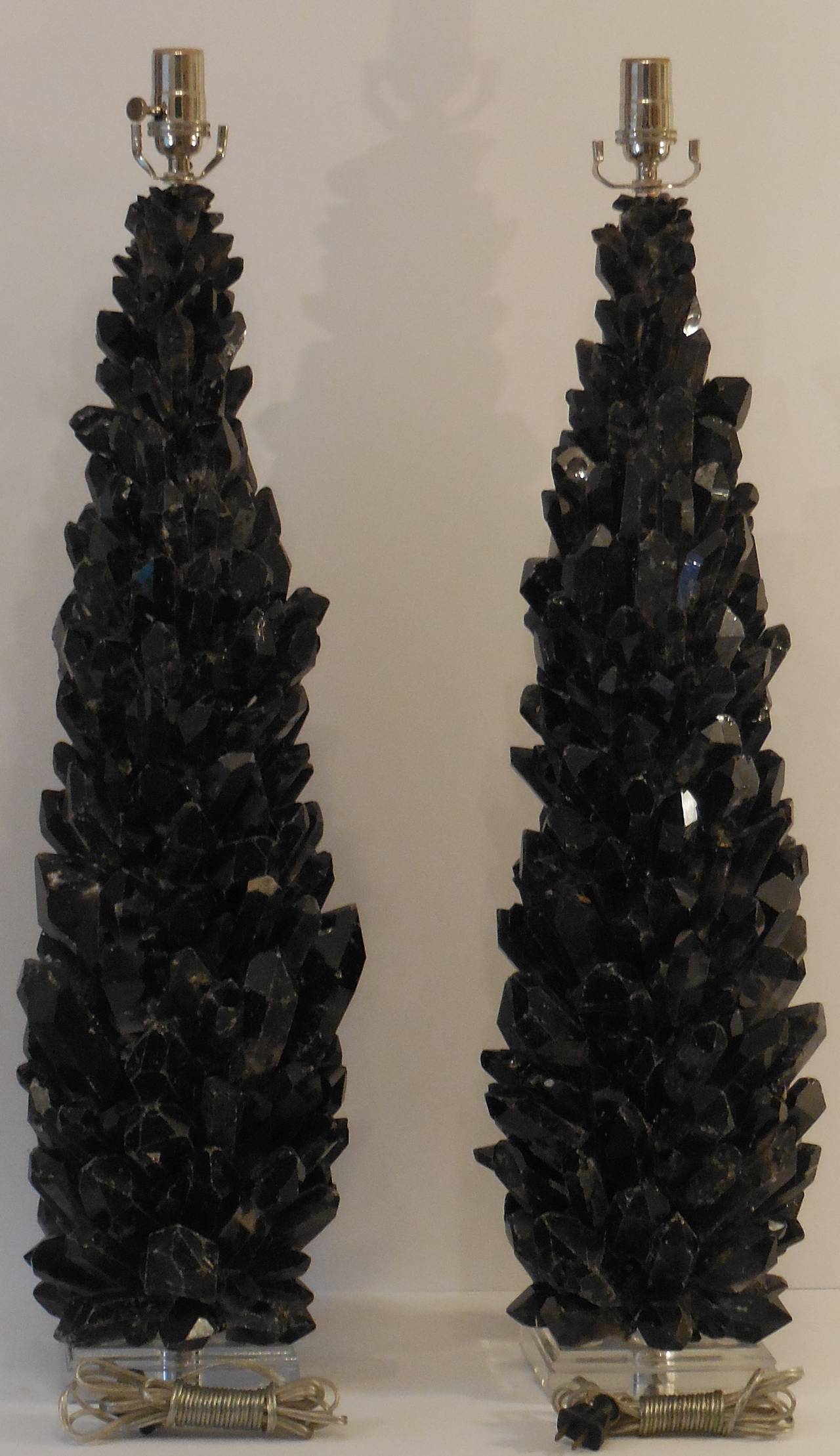 One-of-a-kind pair of table lamps with large and smaller black quartz crystal, put 
together to make impressive piece of art.
Custom-made Lucite base.
Nickel hardware.
Lucite base size is: 5
