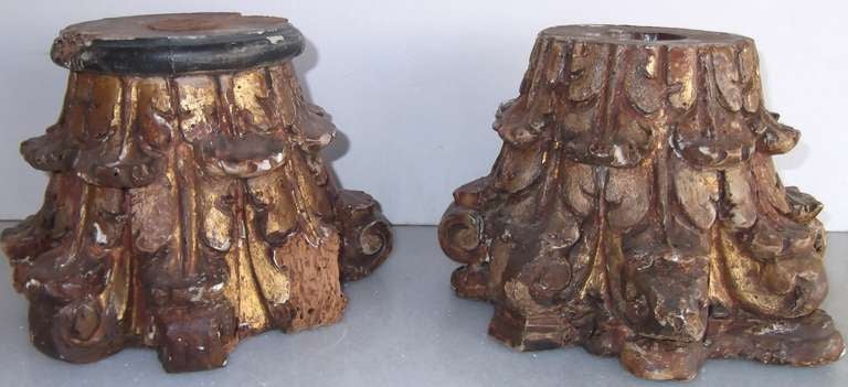 Pair of wooden capitals, covered partially in gold leaf accent. Great as a base for small statue or decorative piece.