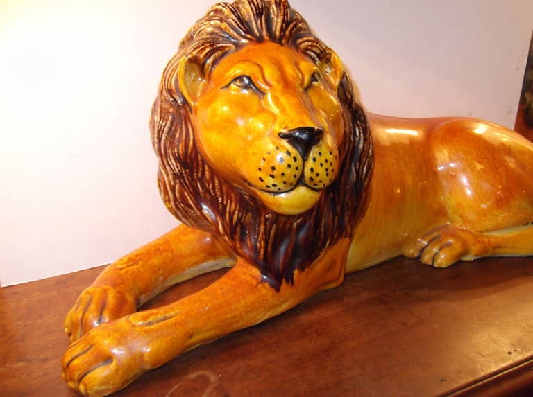 decorative Italian lion sculpture made of ceramic hand painted  , Beautiful shades of orange ,yellow and brown.  Great item for indoor or outdoor.