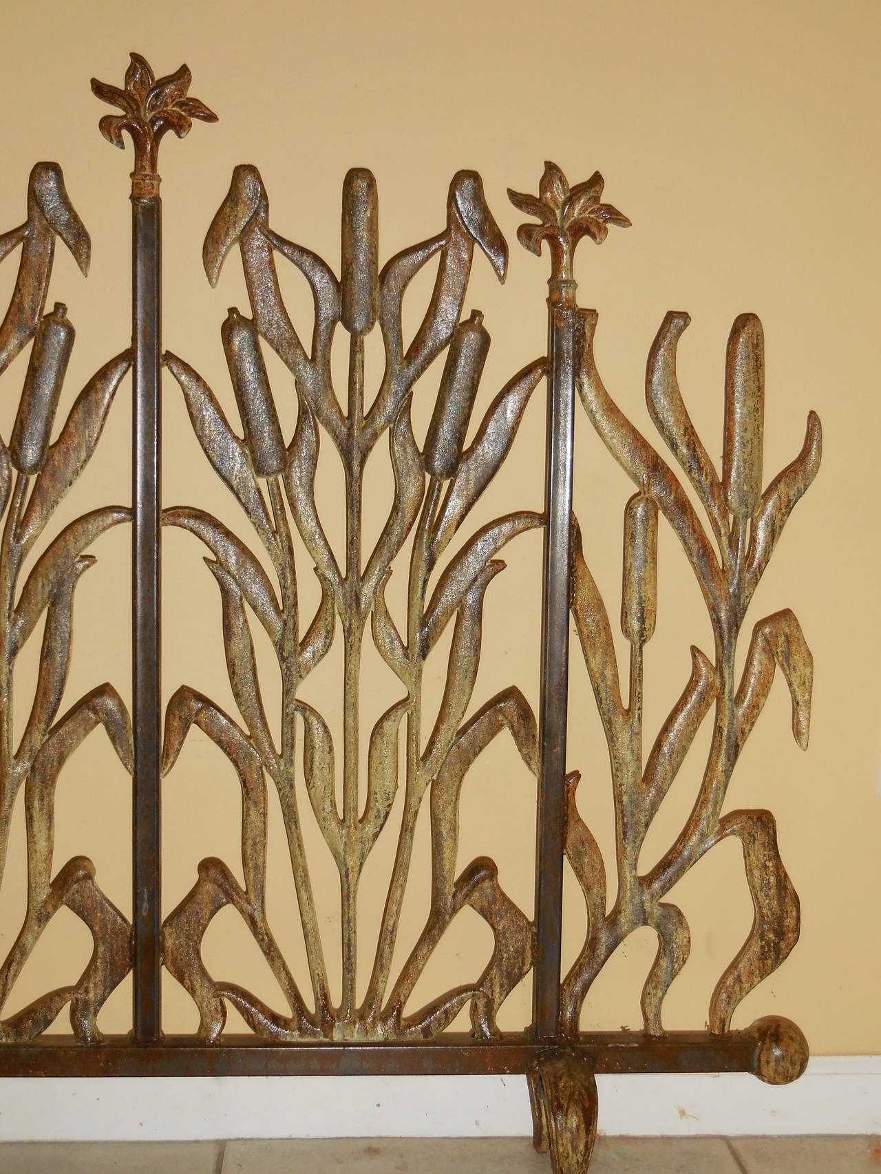 Beautiful fireplace screen made of cast iron ,with unusual cat tail design 
Flowers on the top.
Great patina.