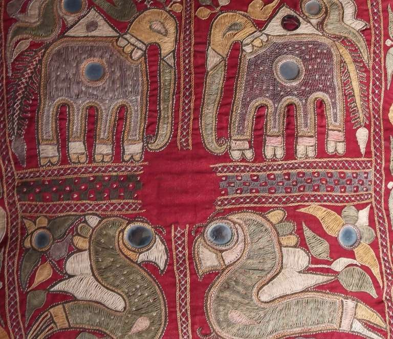 A pair of primitive custom pillow from Thailand. Each pillow has a different fragment embroidery. One with flowers, circles, diamonds and bordered lines all full of vibrant colors (green,blue,yellow and red) and the other pillow with unique looking