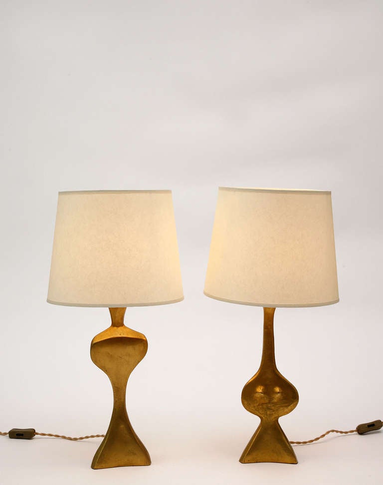 Pair of gold plated bronze table lamps by French sculptor Jacques Jarrige.
