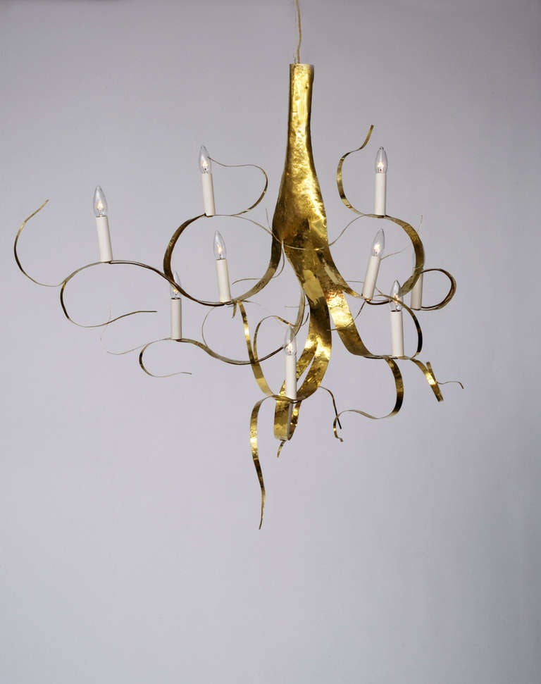 10 light chandelier/sculpture by Jacques Jarrige cut from one sheet of Brass. As in a plant, nothing is cut out or added from the sheet.  After twisting to the desired position the artist hand hammers the brass to give it patina and
