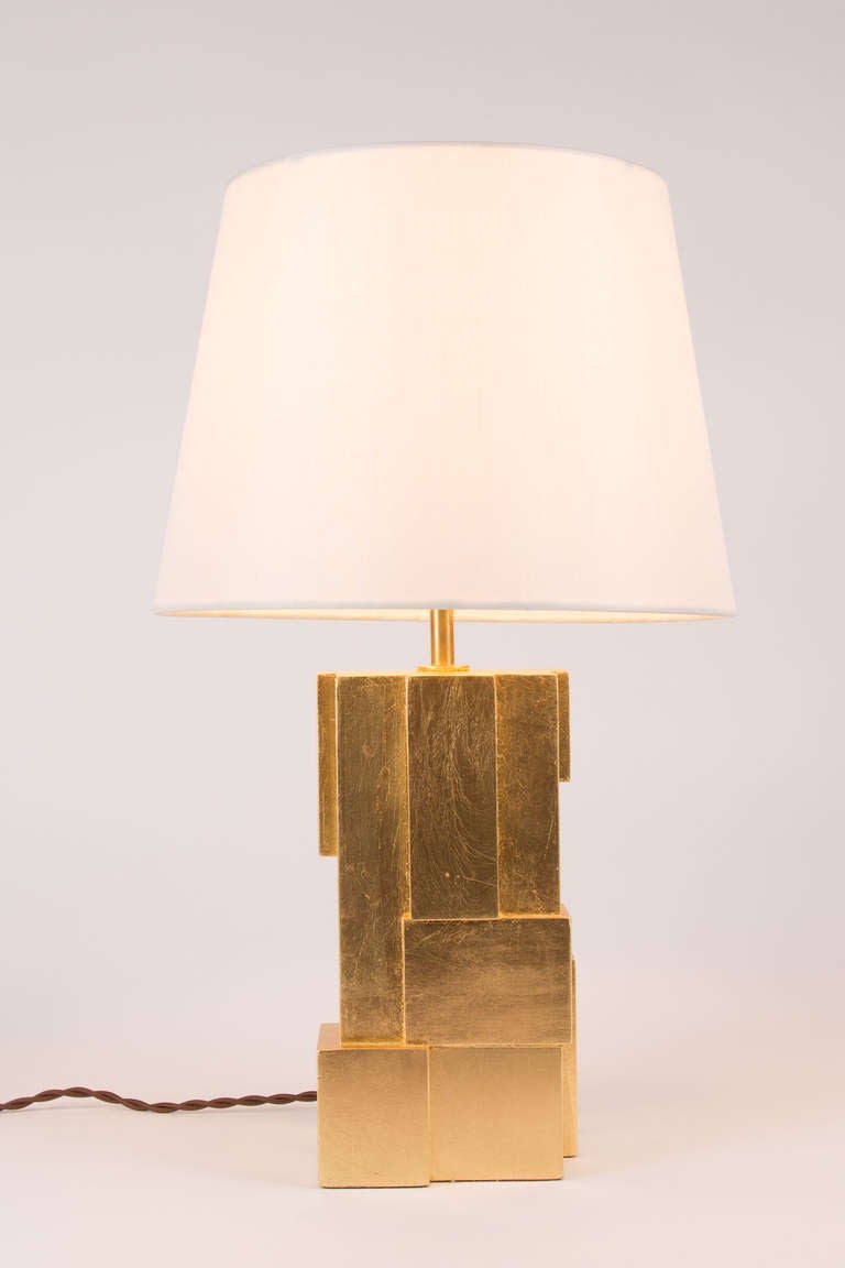 A pair of gilded lamps by Kimille Taylor.