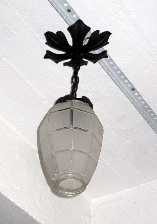 Ceiling fixture/lantern from France dating from the beginning of the 20th century consisting of a Canopy and frame in brass delicately carved in the form of leaves and geometrically shaped sand blasted glass shade.