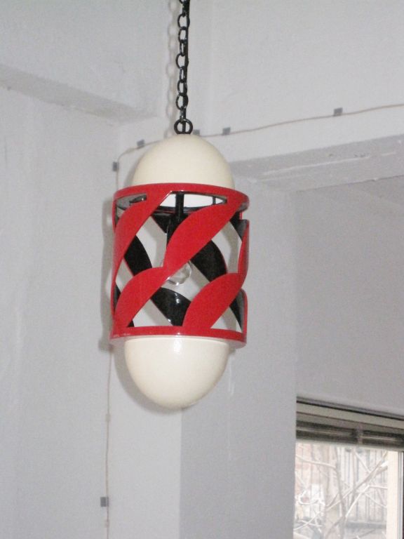 Artist lanterns/ pendants in black and red lacquer with two ends in eggshell in the manner of Jean Dunand from a design by Eileen Gray.