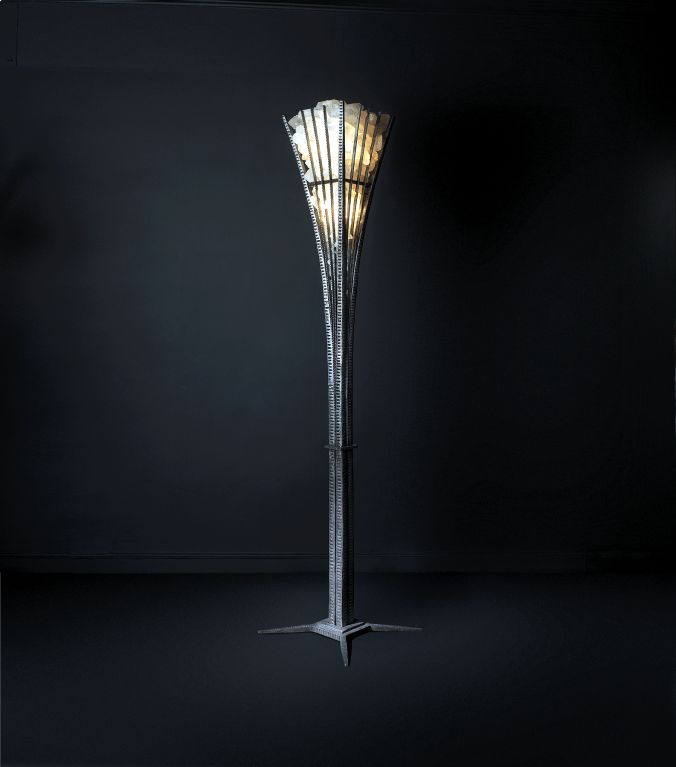 A hand-hammered and Rock Crystral Pair of Floor Lamps by Sylvain Subervie. The base consists of 4 Stems attached to a 2 level square piece. 4 arms shoot up ending in a cage like structure housing the Rock Crystal prisms. The Rock Crystal cage house