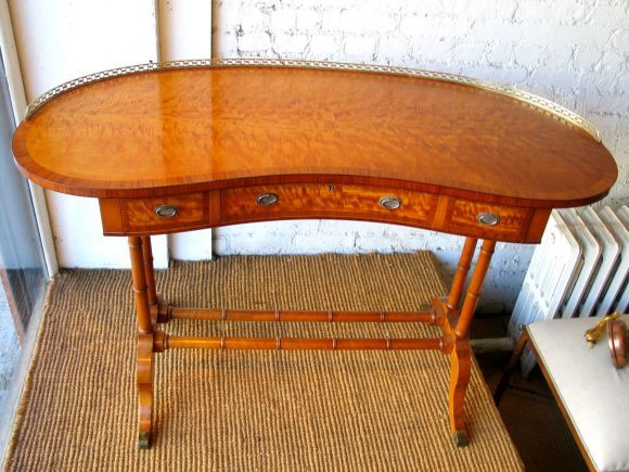 Magnificent French handmade desk of outstanding quality and design from the Louis Philippe period (1830-1848). An elegant curved top is surrounded by a bronze gallery. This top sits on sober faux bamboo legs. 3 drawers with handmade dovetailing and