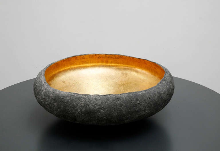 A large centerpiece by Cristina Salusti. Ceramic and 22 Karat gold

Each piece is unique and signed. 

Beginning with a ball of clay, she pinches it into vessels and textures them with stone fragments. After multiple firing it was finally