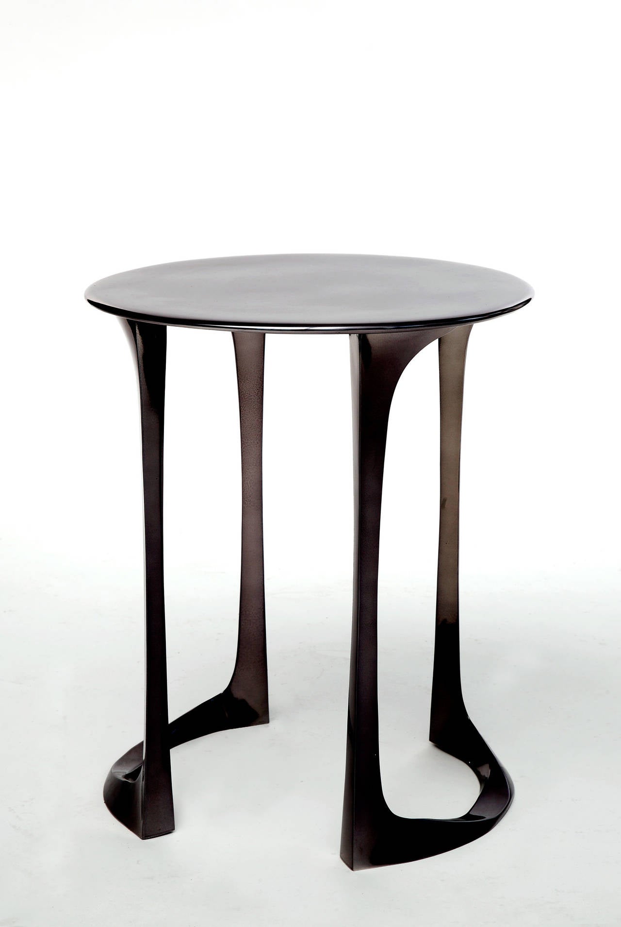 A pair of side tables, gueridons or end tables in black lacquer over polished bronze by French artist Anasthasia Millot.