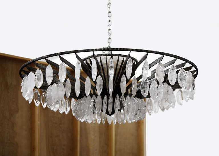A pair of spectacular  Hand Hammered Wrought Iron and Rock Crystal chandeliers by Sylvain Subervie. Priced per chandelier

This Naturalist piece was designed and created by Sylvain Surbervie. The form of Lightning is soberly present in both the arms
