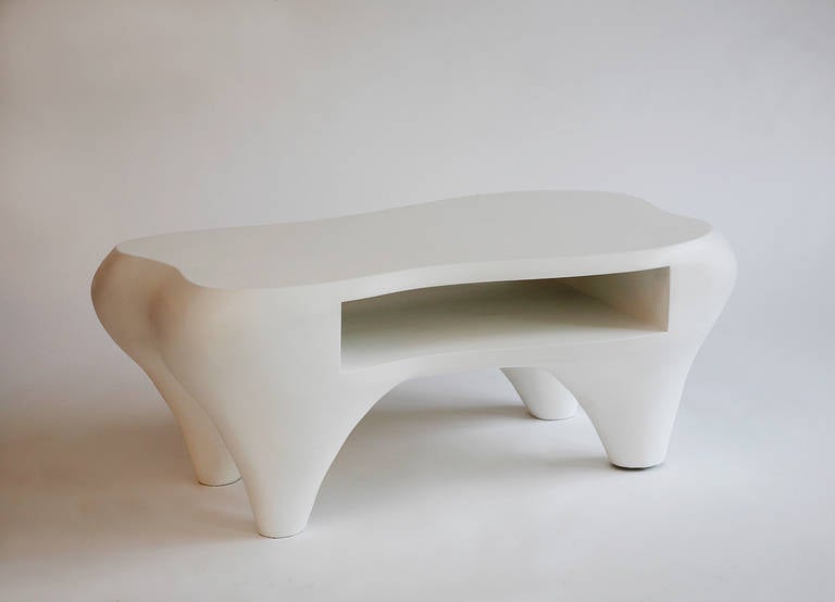 A sensual hand-sculpted coffee table with an open shelf by Jacques Jarrige. MDF sculpted with white patina.

Standing lamps by Jacques Jarrige in white lacquer. Signed. 

Jarrige's work has been recently featured in IDEAT, November 2011, AD