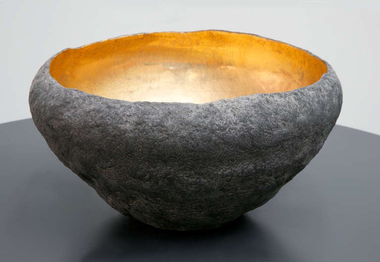 A medium round vessel with 22-karat inside made by artist Cristina Salusti
Beginning with a ball of clay, she pinches it into vessels and textures them with stone fragments. After multiple firing it was finally lustered with 22-karat gold. Its