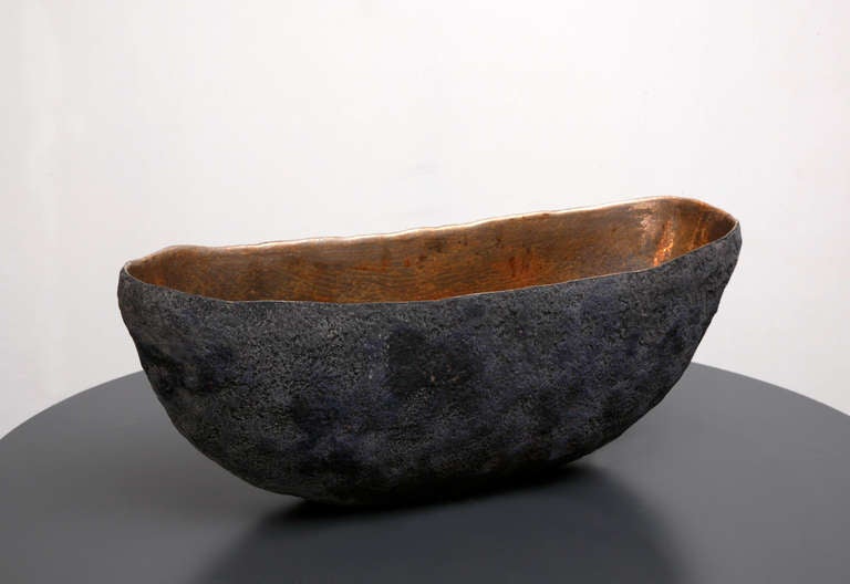 A unique vessel with 22 carat gold inside made by artist Cristina Salusti
Beginning with a ball of clay, she pinches it into vessels and textures them with stone fragments. After multiple firing it was finally lustered with 22 Carat gold over