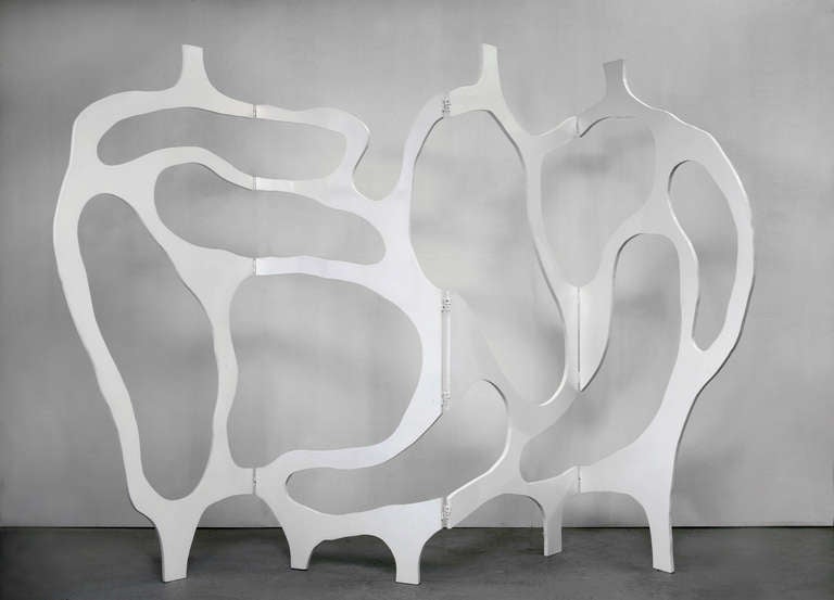 Sculpture/room divider in hand painted White Lacquer by Jacques Jarrige. The openwork frame embodies Jarrige’s line and traces a joyous abstract dance across four panels. The Space comes alive: the voids and the solids become vibrant.

A list of