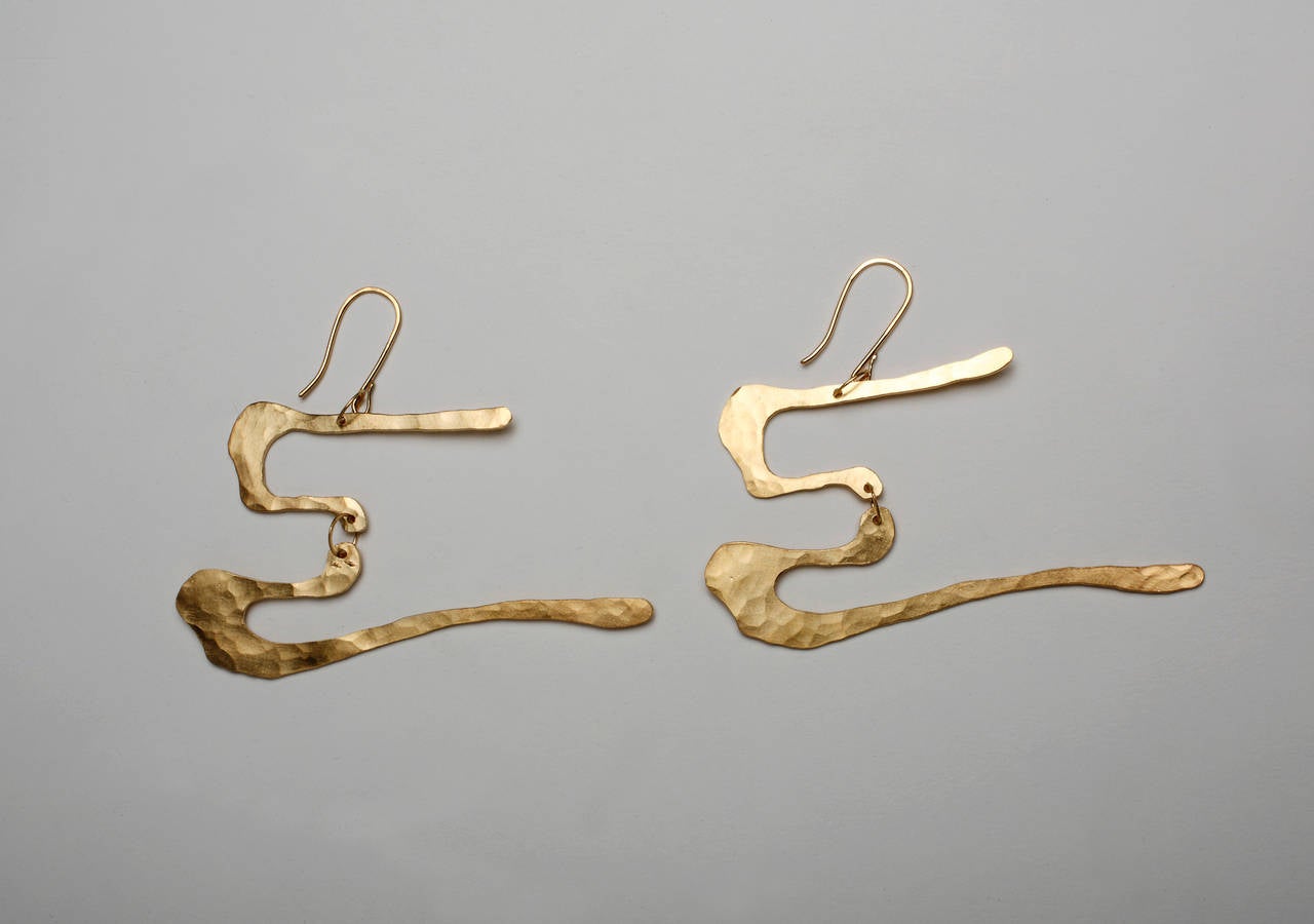 Wearable work of art by Jacques Jarrige. These earrings are hand-sculpted and hammered in silver sterling and gold-plated with 18-Karat, five microns.

This wearable sculpture unmistakable shares Jarrige's vocabulary found in his mobiles, lighting