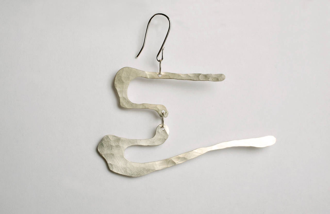 Wearable work of art by Jacques Jarrige. These earrings are hand-sculpted and hammered in silver sterling.

Also available gold-plated 18-karat

This wearable sculpture unmistakably echoes Jarrige's vocabulary found in his mobiles, lighting and