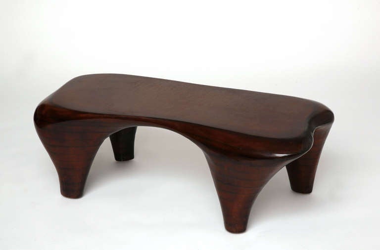 A unique biomorphic shaped coffee table hand-sculpted by Jacques Jarrige. Beautiful mahogany finish

Jarrige's work has been recently featured in IDEAT, November 2011, AD Collector, October 2011, World of Interiors September 2011 and May 2011,