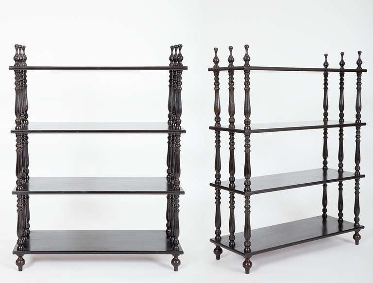 This pair of French Napoleon III period ebonized etageres each has four shelves supported by carved and turned spindles.