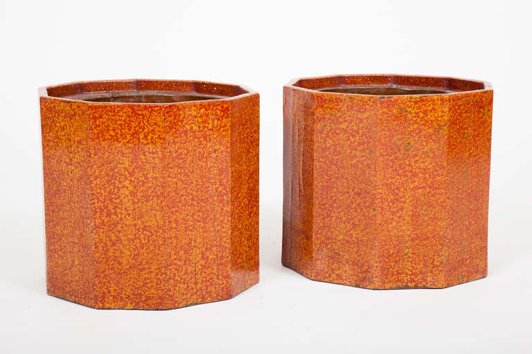 This pair of Japanese Meiji period portable hand warmers, or hibachi, is octagonal in form, decorated with reddish orange lacquer, and fitted with removable copper liners. They are also useable as planters.