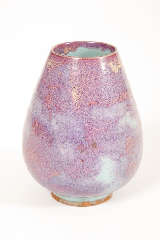 This Chinese Qing Dynasty flambé jarlet is ovoid in form, tapering towards the mouth, decorated with blue and purple glazes in the style of Chun ceramics of the Song dynasty.