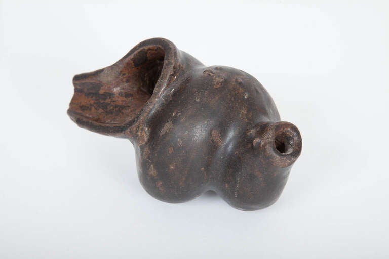 This rare Cambodian stoneware conch shell-form vessel was made of high temperature fired brown stoneware with an iron glaze in the khmer Empire during the twelfth or thirteenth century. Used for ceremonial betel rituals, and possibly blown as a