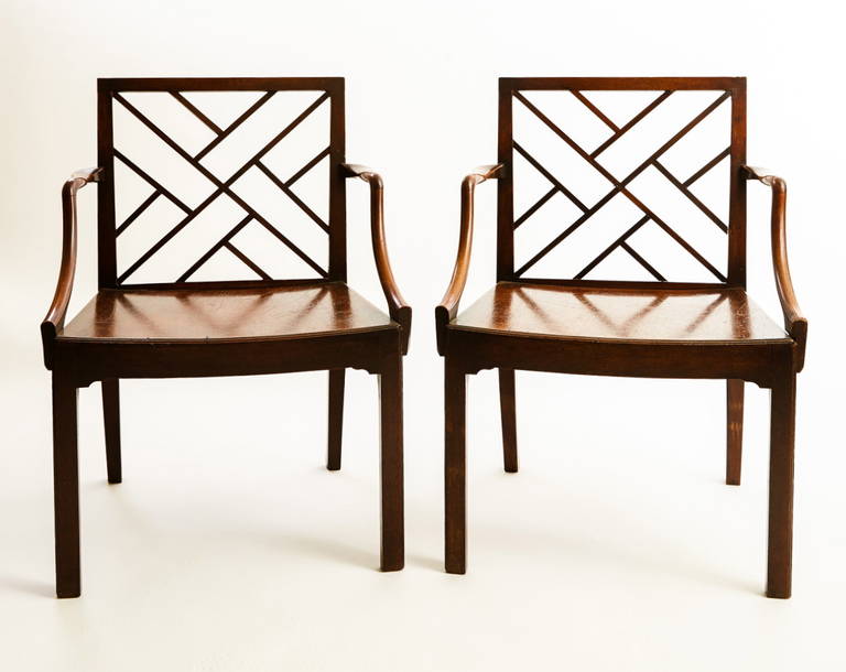 This pair of Scottish George III period Cockpen armchairs each has a rectangular lattice back, joined to the trapezoidal plank seats by serpentine arms, and raised on square chamfered legs, with early, if not original, finish with good patination.