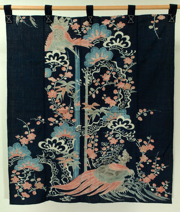 Indigo futon cover depicting a turtle roaring at a swooping crane; both against a sea and landscape.  Plain weave cotton with paste-resist decoration (tsutsugaki) of delicate palette and intricate detailing.