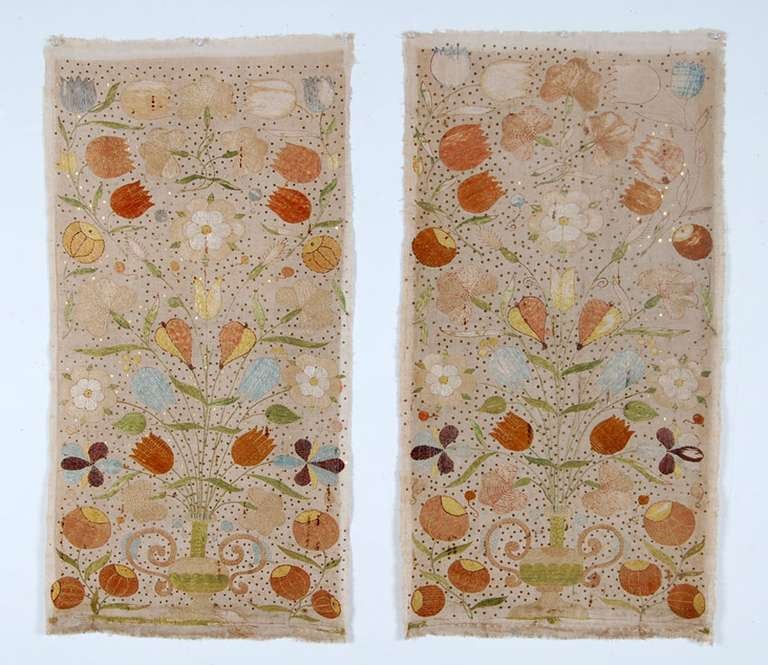 A pair of Castelo Branco embroidered hangings each with a center vase with flowers of blues and browns. This style is clearly influenced by Indian Portuguese embroideries from Northwest India. Castelo Branco embroideries differ from their Indian