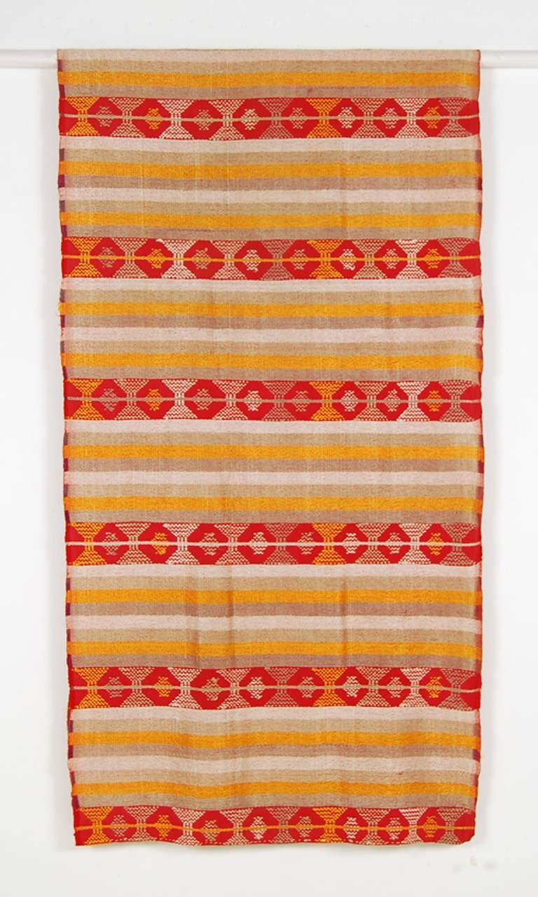 Ceremonial skirt from Samayac, Guatemala. Unlike other regional skirts was worn wrapped without a sash. The striped tabby ground is decorated with a supplementary weft. Weft is selvedge to selvedge and quite narrow. Along the edges, which curled
