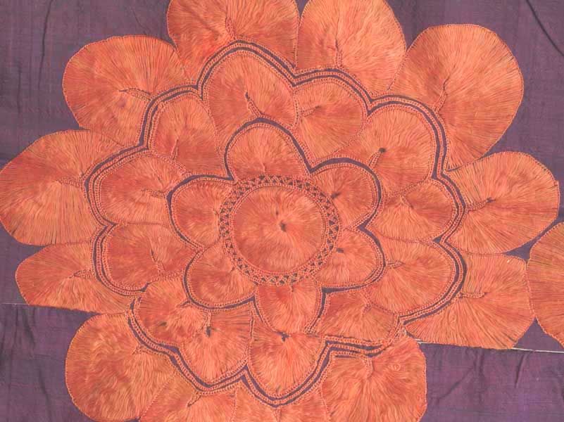 An abochhini with a floral design. Silk embroidered with floss silk using a chain stitch technique as well as a sindhi stitch, which is characterized by satin stitches radiating from a button-hole stitch.