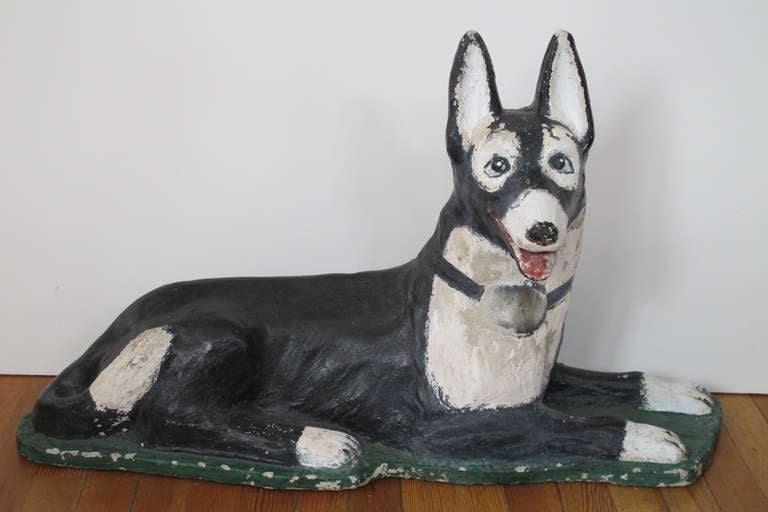 Guard dog for the yard made of painted concrete. This perky dog is more likely to attract and greet visitors than scare them away. Fanciful graphic paint.