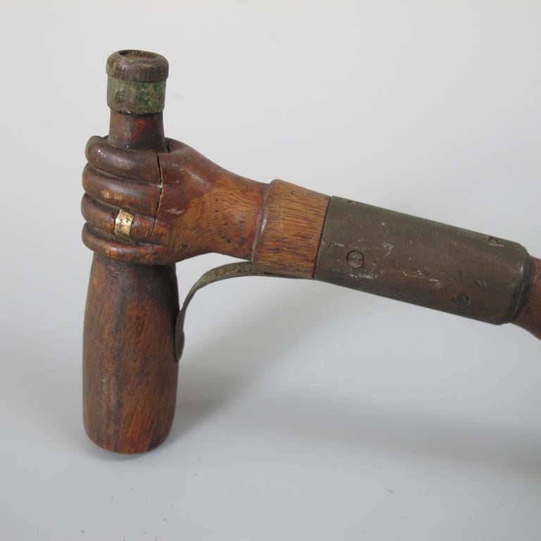 Metal Hand Holding A Bottle Carved Cane For Sale